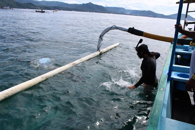 Snorkeling Tour at Blue Lagoon with Private Hotel Transfer - Boarding the traditional boat in Padang Bai